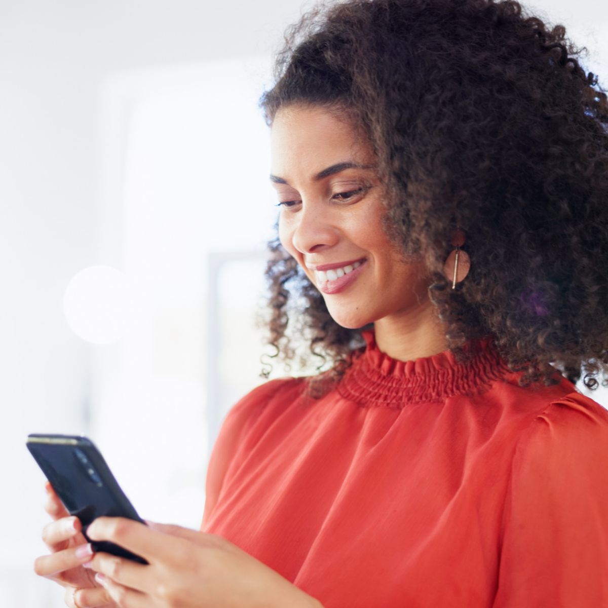 woman in orange with phone