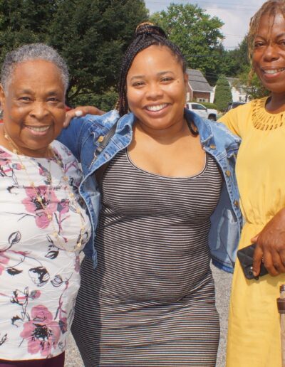 three women standing in a parking lot