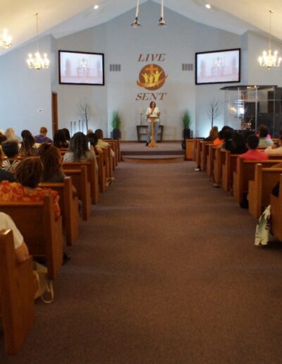 chapel meeting with people listening to a speaker